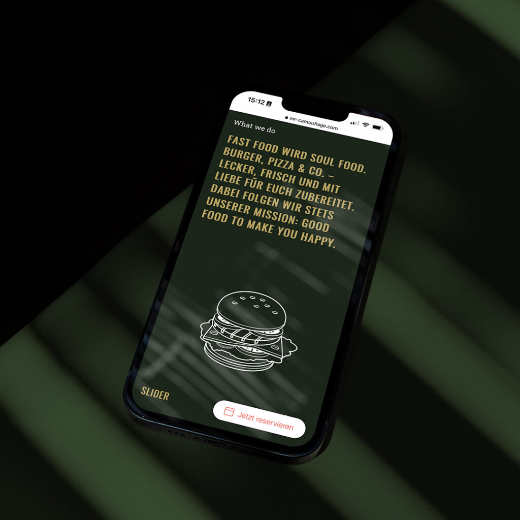 iPhone auf grünem Hintergrund, im Display Mr. Camouflage Website